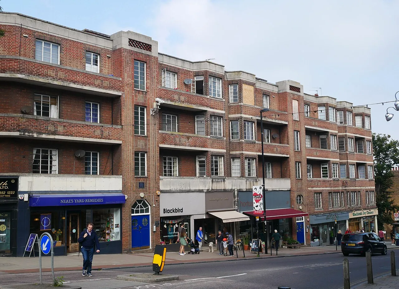 1930s red-brick mansion block above shops in Blackheath Village, South East London