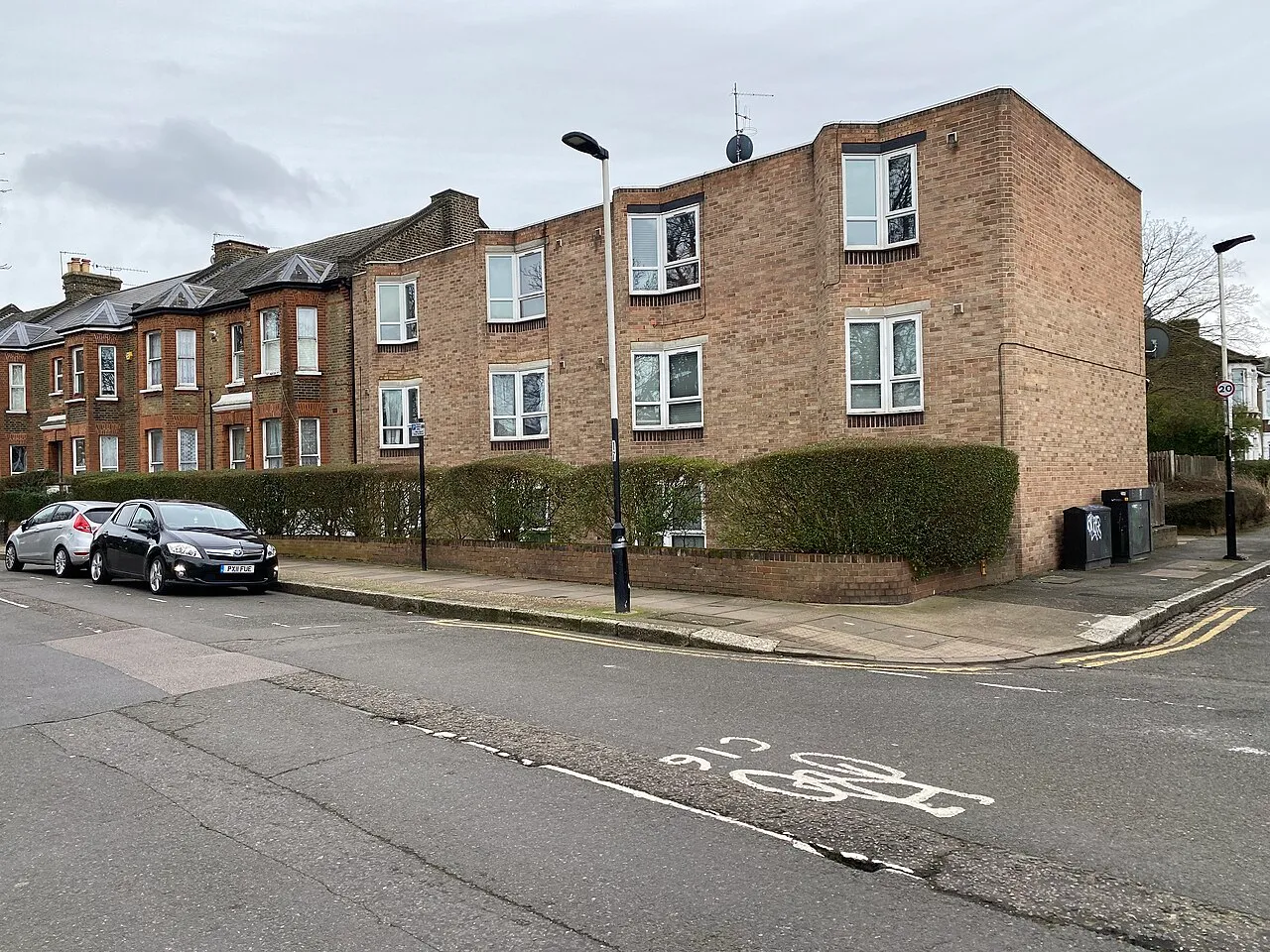 Low-rise brick block of flats on a corner plot in Forest Gate, East London